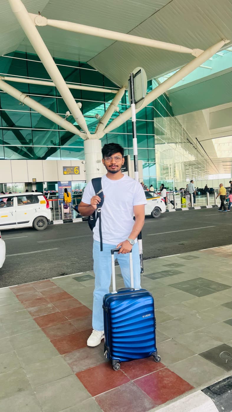Aftab with a suitcase at the airport, on the way to Hyderabad.